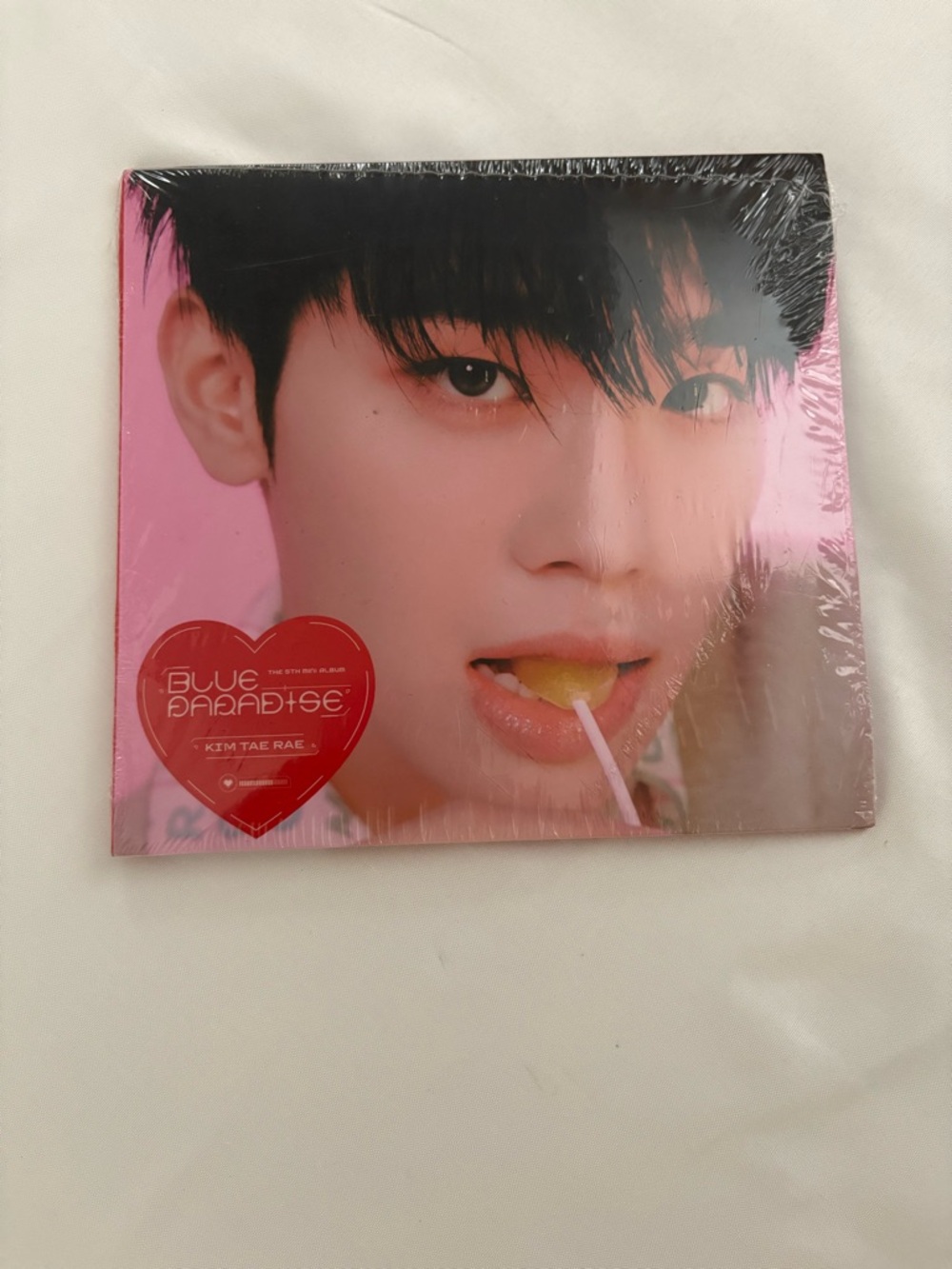 K-Pop Photobook/Album with Pink Cover featuring Close-Up Portrait